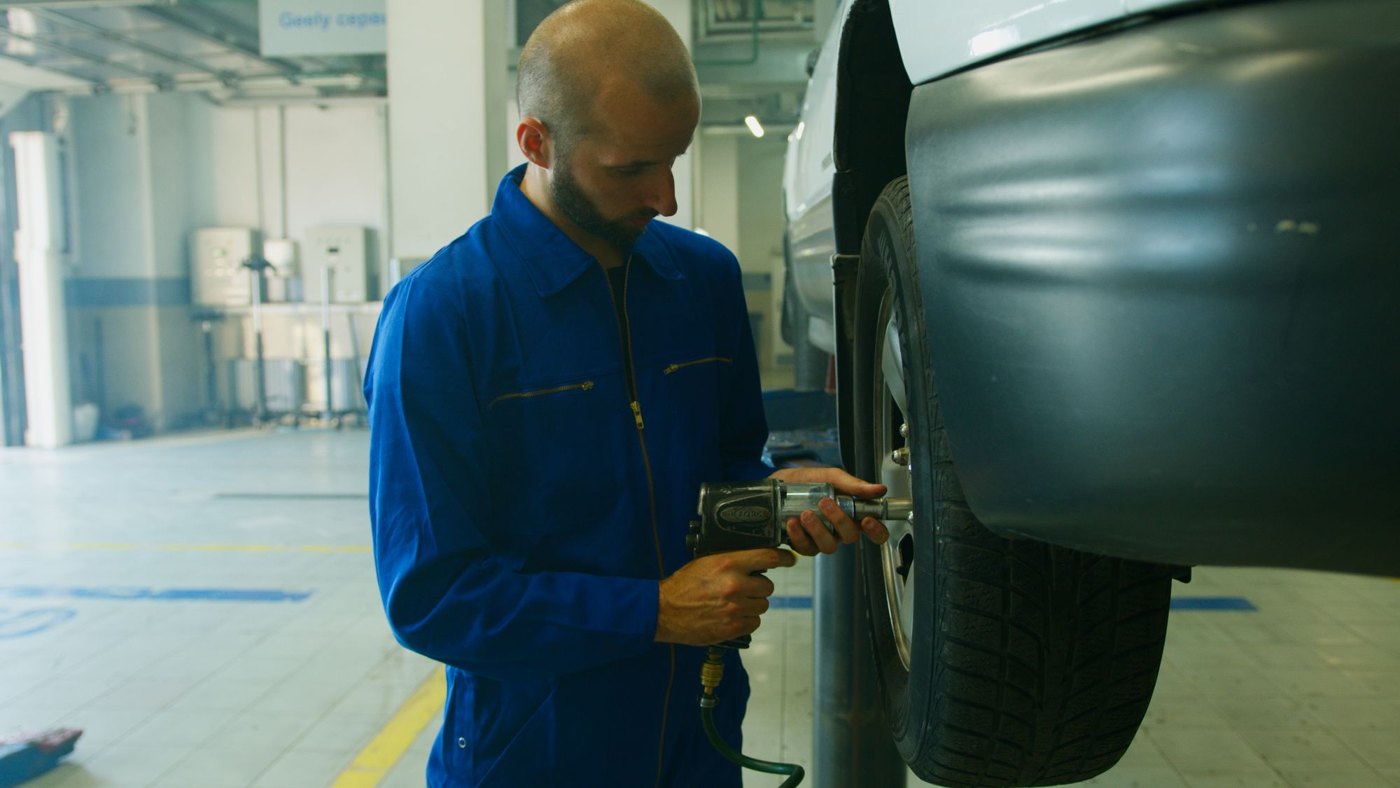 Illustrative photo of a mechanic servicing a tire